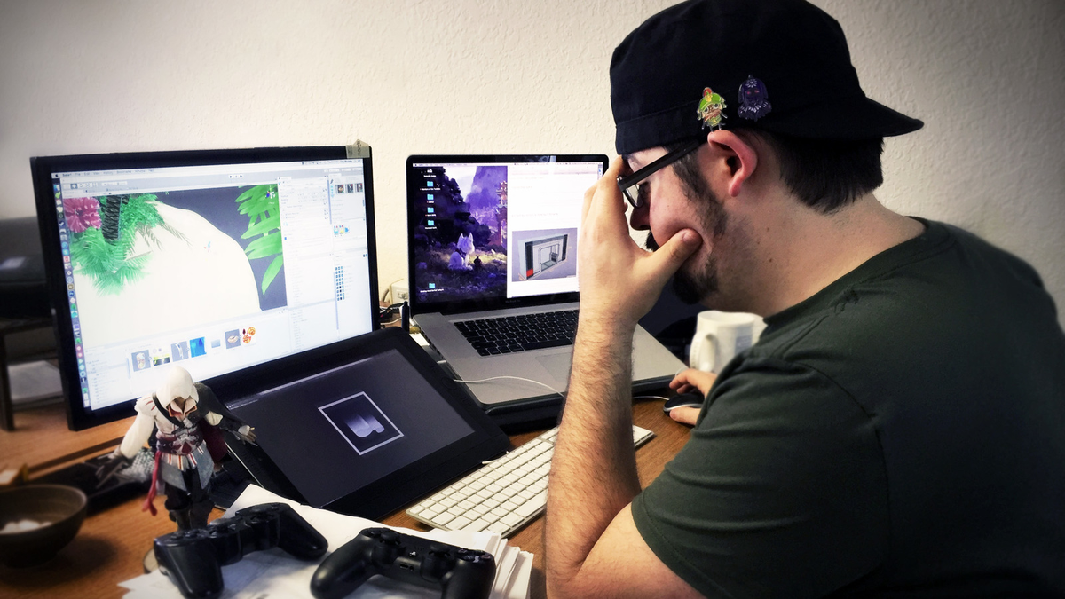 An individual working on console game development on his personal computer.